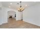 Elegant dining room with hardwood floors, modern chandelier, and a fireplace in the adjacent living room at 2111 E Alameda Ave, Denver, CO 80209