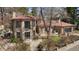 Beautiful two-story stone house with a tile roof and manicured landscaping at 2111 E Alameda Ave, Denver, CO 80209