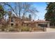 Exterior view of the home showing beautiful architecture, mature trees and landscaping at 2111 E Alameda Ave, Denver, CO 80209