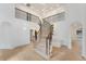 Elegant foyer with a grand staircase, chandelier, and light hardwood floors at 2111 E Alameda Ave, Denver, CO 80209