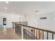 Upstairs hallway features hardwood floors, decorative lighting, and metal railings at 2111 E Alameda Ave, Denver, CO 80209