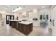 Modern kitchen featuring a large center island with marble countertops, stainless appliances, and custom cabinetry at 2111 E Alameda Ave, Denver, CO 80209