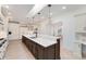 Open kitchen with a large island, marble countertops, and modern appliances at 2111 E Alameda Ave, Denver, CO 80209