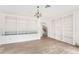 Living room featuring custom built-in shelving, chandelier lighting, and archway to stairs at 2111 E Alameda Ave, Denver, CO 80209
