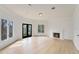 Spacious living room with fireplace, hardwood floors, and ample natural light at 2111 E Alameda Ave, Denver, CO 80209