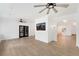 Open living room with hardwood floors, ceiling fans, black french doors, and media center at 2111 E Alameda Ave, Denver, CO 80209