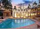 View of the pool and unique home exterior, featuring decorative lights and balcony at 2111 E Alameda Ave, Denver, CO 80209