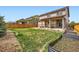 Spacious backyard with a covered patio, seating, well-kept lawn, and garden beds at 350 N Langdale Ct, Aurora, CO 80018