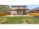 Large backyard featuring a covered patio and well-maintained lawn with a wooden fence at 350 N Langdale Ct, Aurora, CO 80018