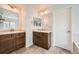 Modern bathroom featuring dual vanities, mirrors, and a separate door offering privacy at 350 N Langdale Ct, Aurora, CO 80018