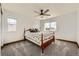 Bright carpeted bedroom featuring two windows and a ceiling fan at 350 N Langdale Ct, Aurora, CO 80018