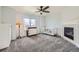 Cozy carpeted bedroom features a fireplace, ceiling fan and ample natural light at 350 N Langdale Ct, Aurora, CO 80018