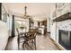 Inviting dining area with wood floors and a modern chandelier overlooking the kitchen at 350 N Langdale Ct, Aurora, CO 80018