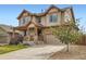 Charming two-story house boasting a stone-accented garage and welcoming covered front porch at 350 N Langdale Ct, Aurora, CO 80018