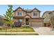 Inviting two-story home with a stone facade, covered porch, and well-maintained lawn at 350 N Langdale Ct, Aurora, CO 80018