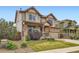 Attractive two-story home featuring a stone garage facade, covered porch, and manicured landscaping at 350 N Langdale Ct, Aurora, CO 80018