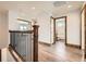 Second floor hallway leading to an open bathroom at 350 N Langdale Ct, Aurora, CO 80018