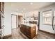 Open kitchen with dark wood floors, an island, white walls and recessed lighting at 350 N Langdale Ct, Aurora, CO 80018