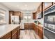 Well-lit kitchen featuring stainless appliances, wooden cabinets and a large island at 350 N Langdale Ct, Aurora, CO 80018