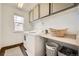 Functional laundry room with a window, cabinetry and a washing machine at 350 N Langdale Ct, Aurora, CO 80018