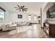 Spacious living room featuring modern furnishings, wood floors, and a decorative ceiling fan at 350 N Langdale Ct, Aurora, CO 80018