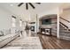 Open-concept living room with hardwood floors, a stone fireplace, and comfortable seating at 350 N Langdale Ct, Aurora, CO 80018