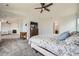 Spacious carpeted main bedroom featuring a ceiling fan, ensuite bath and walk-in closet at 350 N Langdale Ct, Aurora, CO 80018
