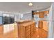 Bright kitchen features wood cabinets, white appliances, and island with breakfast bar, and wood floor at 1301 Speer Blvd # 1008, Denver, CO 80204