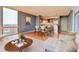 Open living area with a modern sofa, wood floors, dining table, and an adjacent kitchen at 1301 Speer Blvd # 1008, Denver, CO 80204