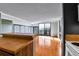 Bright living room with sliding glass doors to balcony, wood floor and breakfast bar with an adjacent kitchen at 1301 Speer Blvd # 1008, Denver, CO 80204