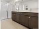 Bathroom featuring double vanity with large mirrors, glass shower and tiled floors at 21134 E 63Rd Dr, Aurora, CO 80019