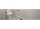 New bathroom featuring a tiled floor, baseboard and low flow toilet at 21134 E 63Rd Dr, Aurora, CO 80019