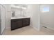Bathroom featuring dual vanity, tile flooring, and glass enclosed shower at 21134 E 63Rd Dr, Aurora, CO 80019