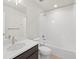 Well-lit bathroom with white tiled shower and modern vanity with ample storage at 21134 E 63Rd Dr, Aurora, CO 80019