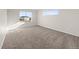 Spacious, light-filled carpeted bedroom with large window with view to the outside at 21134 E 63Rd Dr, Aurora, CO 80019