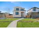 Charming two-story home featuring a well-manicured lawn and inviting walkway at 21134 E 63Rd Dr, Aurora, CO 80019