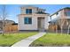 Charming two-story home boasts a modern design, well-maintained lawn, and inviting entrance at 21134 E 63Rd Dr, Aurora, CO 80019