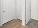 Hallway with wood-look flooring leading to rooms with carpet at 21134 E 63Rd Dr, Aurora, CO 80019