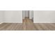 Hallway with wood-look floors leads to carpeted stairs with white trim and neutral paint at 21134 E 63Rd Dr, Aurora, CO 80019