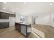 Bright, modern kitchen featuring an island with stainless steel dishwasher and wood flooring at 21134 E 63Rd Dr, Aurora, CO 80019