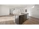 Open-concept kitchen island featuring a sink and stainless steel dishwasher at 21134 E 63Rd Dr, Aurora, CO 80019