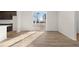 Open living room showcasing wood-look floors, sliding glass doors, and plenty of natural light at 21134 E 63Rd Dr, Aurora, CO 80019
