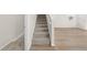 Carpeted staircase with white railing and wood-look floors at 21134 E 63Rd Dr, Aurora, CO 80019