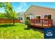 Exterior view of the home showcasing a spacious backyard and wood deck at 5720 S Tempe Ct, Aurora, CO 80015