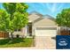 Charming two-story home with landscaped front yard and attached two-car garage at 5720 S Tempe Ct, Aurora, CO 80015