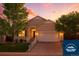 Charming two-story home with landscaped front yard and attached two-car garage at 5720 S Tempe Ct, Aurora, CO 80015