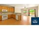 Bright kitchen open to the living area featuring laminate countertops and appliances at 5720 S Tempe Ct, Aurora, CO 80015