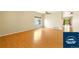 An open living room with light hardwood flooring, bright natural light, and a ceiling fan at 5720 S Tempe Ct, Aurora, CO 80015