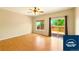 Bright living room featuring wood floors, ceiling fan and sliding glass doors to the outdoor deck at 5720 S Tempe Ct, Aurora, CO 80015