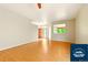 Spacious living room featuring light hardwood floors, neutral walls, and a large window at 5720 S Tempe Ct, Aurora, CO 80015